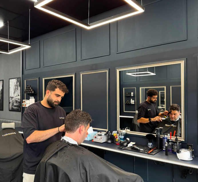 Omar cutting hair at Homme Barbers